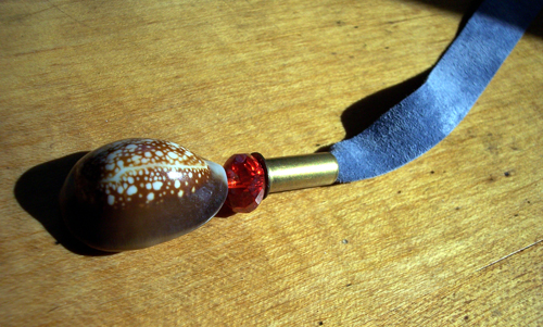 Cowrie shell pendant on leather lace bookmark with glass bead