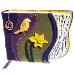 handcarved yellow leather chickadee and daffodil on green, purple, and blue leather photo album with copper spiral bookmark