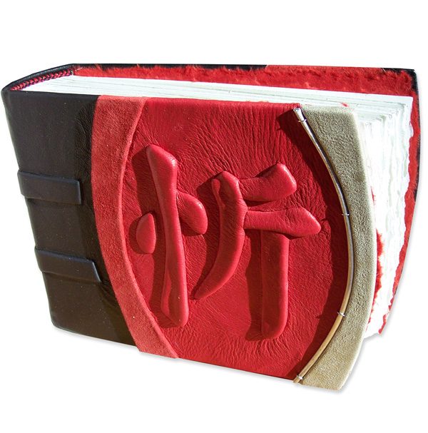 Chinese kanji character JOY embossed under red leather on handbound scrapbook album
