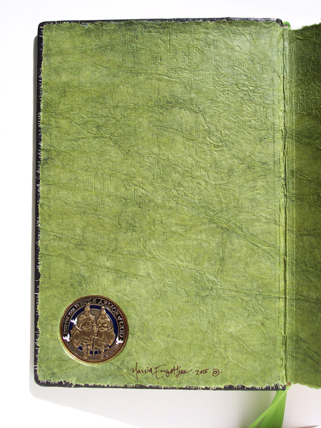 Metal Coin inset into inner Bible cover