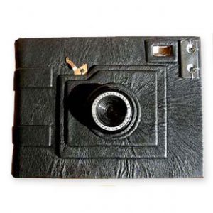 Camera shaped Photo Album using a camera lens and parts over black leather