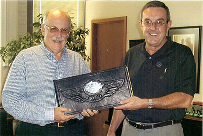 Custom leather 100th Anniversary photo album with winged emblem presented to Harley-Davidson executive