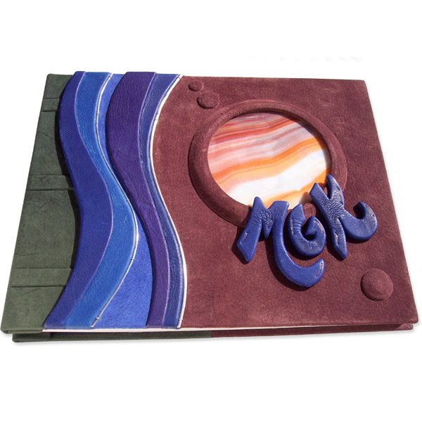 stained glass window as Jupiter in leather book cover with blue initials