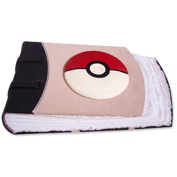 handcarved and leather wrapped convex pokeball on suede pink leather scrapbook album, red and white leather pokeball