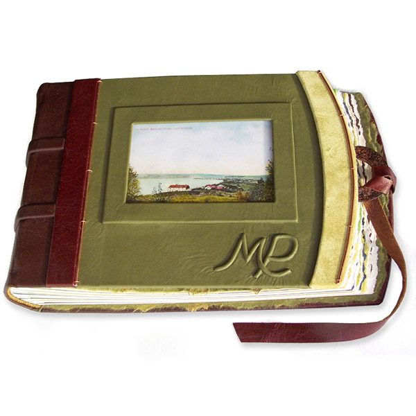 green leather photo album with photo under glass, embossed initials, leather lace closure