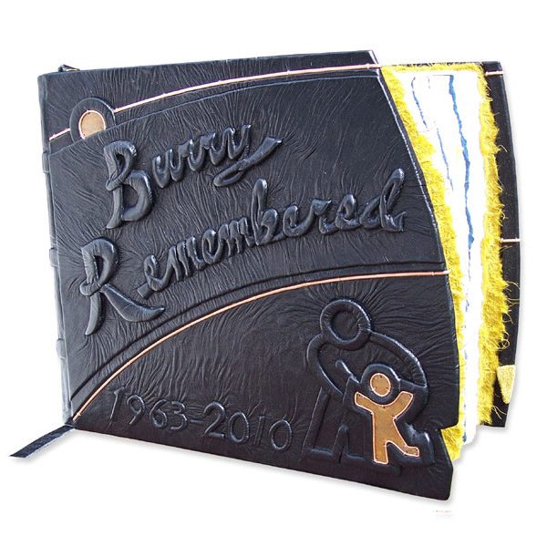 Custom leather Doctor Retirement scrapbook with embossed lettering, dates, Children;s Hospital logo with copper child