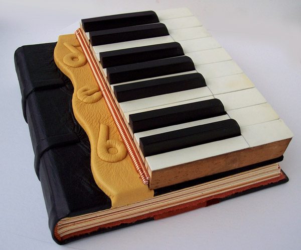 leather piano journal with embossed name Deb, piano keys, piano wire