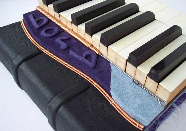 custom leather musician journal with piano keys, piano wire, embossed name Barb