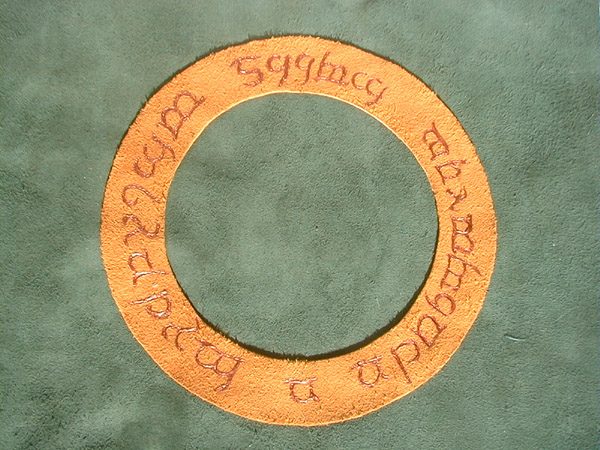 closeup of Lord of the Rings leather book cover with handpainted copper Elvish lettering on gold leather ring