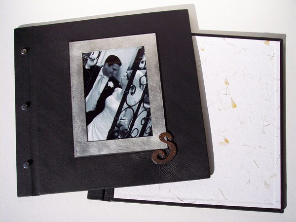 black leather screwpost wedding book with silver framed black and white photograph