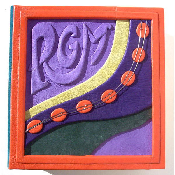 purple and green custom leather box lid with orange border and dots linked with wire