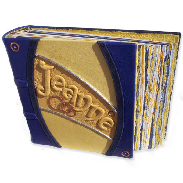 yellow and blue leather photo album with embossed name and copper
