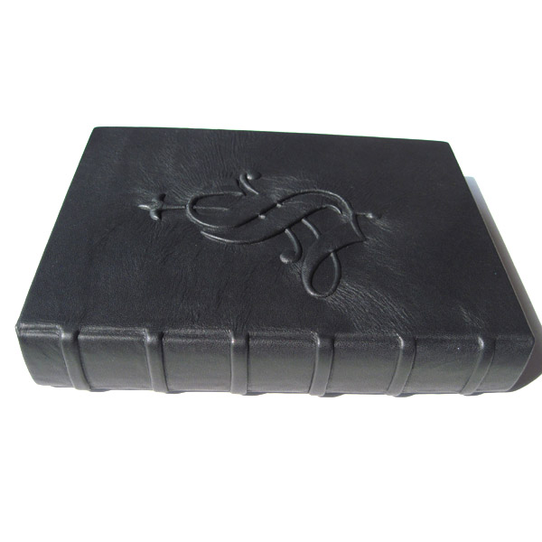 rounded spine with faux binding cords on black leather clamshell box