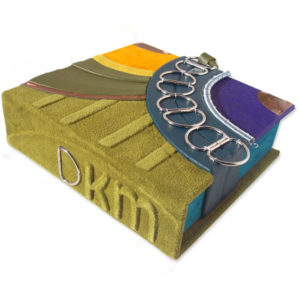 D rings on suede moss green clamshell box with embossed intials DKM