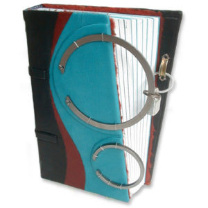 turquoise leather black journal with two steel rings and padlock closure over angled diary edge