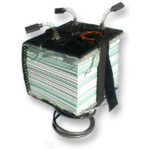 small thick handbound book mounted on a spring with 3 brush springs on the top cover, black leather with lace closure