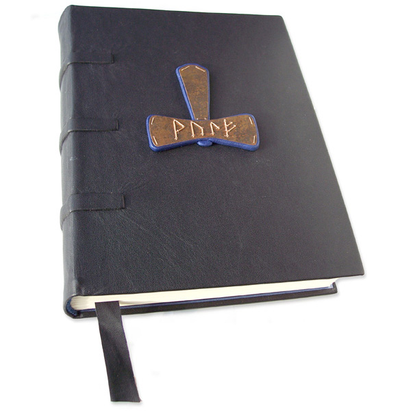 black leather Native American custom journal with copper name on raised blue leather symbol