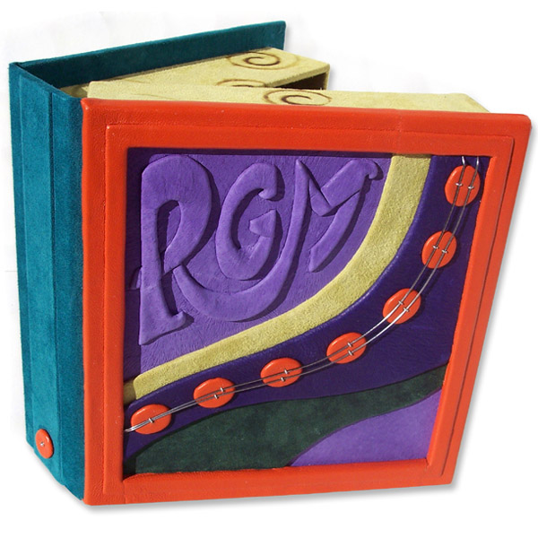 custom bright leather box with embossed purple initials RGM and orange leather dots