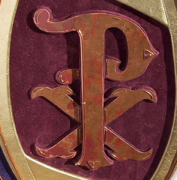 Christian symbol PX Chi Rho sculpture on leather book cover, capped in copper with gold frame