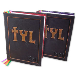 TYL, Thank you Lord devotional prayer books with copper TYL initials on black leather with copper wire trim.