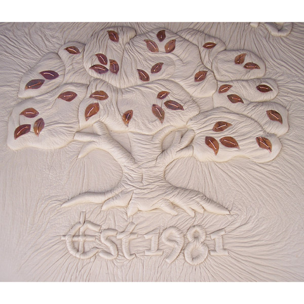 Established 1981 embossed under ivory leather with tree business logo and copper leaves