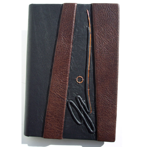 embossed signature on brown and black leather padfolio notebook cover with copper washer and wire