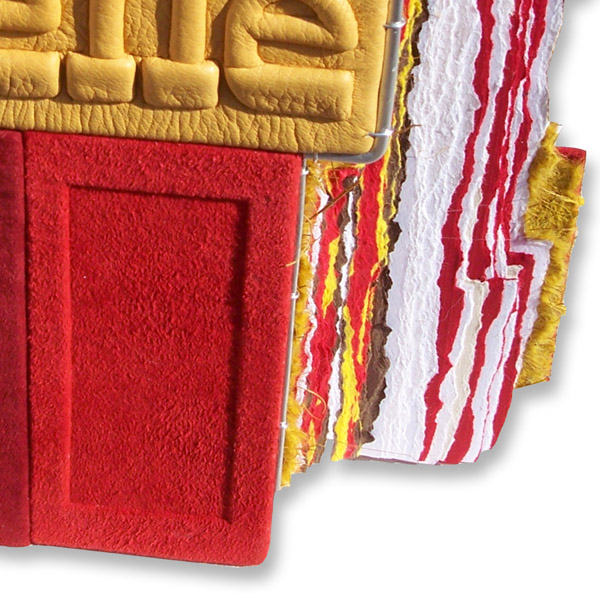 stepped edge on leather book covers and deckled edge pages in reds and golds