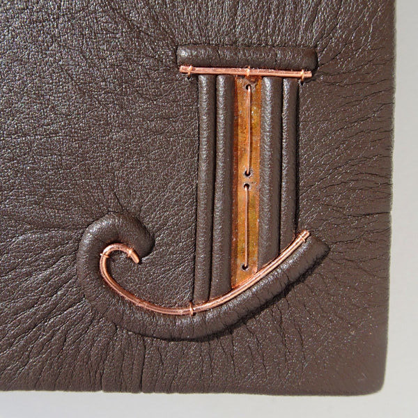Embossed Initial J on Brown Leather Book Cover with Inset Copper Sheet and Wire